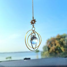 a car dashboard with a wind chime hanging from it's side