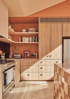 a kitchen with wooden cabinets and an oven in the center, surrounded by open shelving