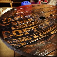 an old wooden table that has been turned into a coffee shop sign on the top