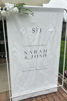 a wedding sign with flowers on it