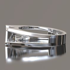 two silver rings sitting next to each other on top of a white surface with reflections