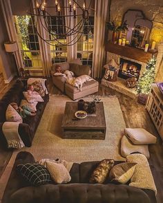 a living room filled with lots of furniture and a fire place in the middle of it