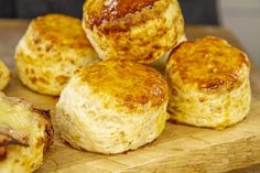 some biscuits sitting on top of a wooden cutting board