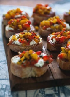 small appetizers are arranged on a wooden tray