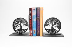 two bookends that have books on them and one is shaped like a tree