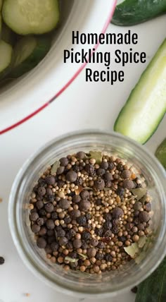 a glass jar filled with spices next to cucumbers