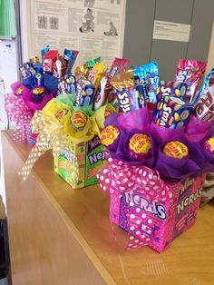 candy bouquets are lined up on a desk