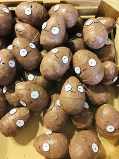 a box filled with lots of cut up potatoes covered in googly eyes and brown paper