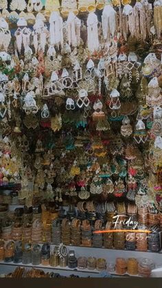 a store with lots of different types of jewelry hanging from it's walls and ceiling