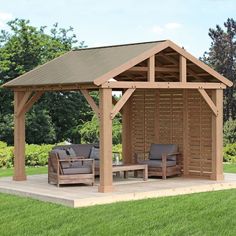 a wooden gazebo sitting on top of a lush green field