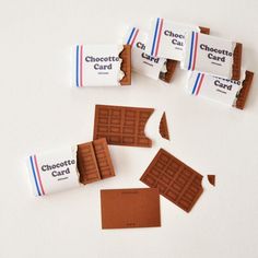 chocolate cards and pieces of paper on a white surface with the word chocotti card cut out