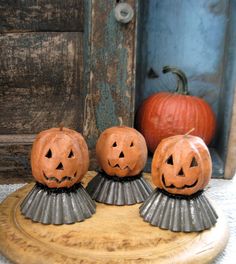 three carved pumpkins sitting on top of a table