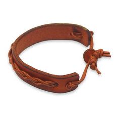 a close up of a leather bracelet on a white background