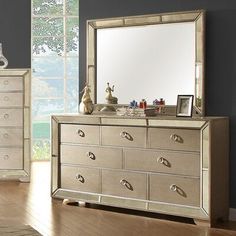 a dresser and mirror in a room with hardwood floors