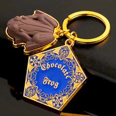 a gold colored keychain with a blue background and the words sprobat boys on it