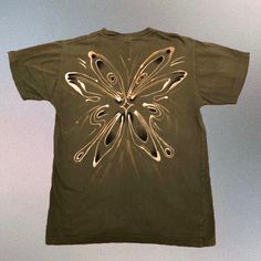 a t - shirt with an image of a butterfly on it's chest and wings