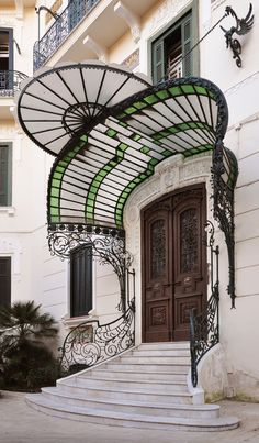 an entrance to a building with stairs leading up to it and a door on the side