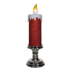 a red candle with white frosting and a yellow flame in the center on a silver stand