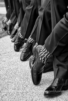 a row of men's dress shoes lined up against each other in black and white