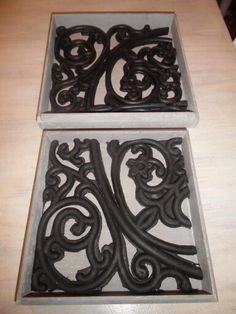 two square trays sitting on top of a table next to each other with decorative designs