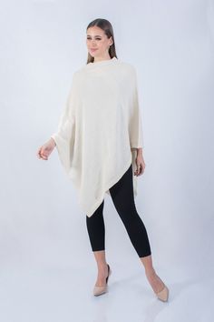 Versatile and elegant knitted poncho, made with fine baby alpaca fiber, enhance your style with a touch of elegance and modernity for any occasion, it is perfect for a fall winter season, soft, warm and cozy We develop our garments from design, through different production processes to the finished garment. Our collection of products is inspired and developed using the best materials such as fine alpaca fiber and other blends, using modern textile machinery that helps us have better finishes wit Elegant Long Sleeve One Size Poncho, Elegant Beige One Size Poncho, Elegant One Size Beige Poncho, One Size Cream Poncho, Elegant Beige Poncho, Elegant Oversized Cape Poncho, Oversized Long Sleeve Cream Poncho, Elegant Oversized Poncho Cape, Cream Oversized Long Sleeve Poncho