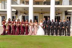 a large group of people standing in front of a building with white pillars and columns