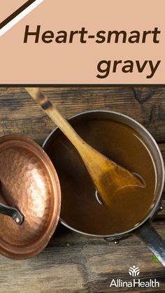 a wooden table topped with pots and pans filled with liquid next to a spoon