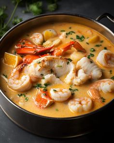 a pan filled with shrimp and vegetables on top of a table