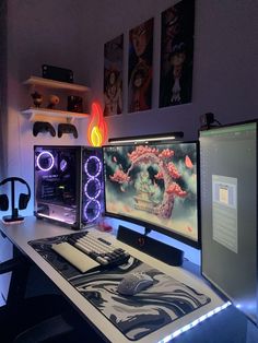 three computer monitors sitting on top of a desk next to a keyboard and monitor screen