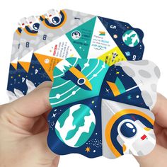 someone holding up some space themed stickers to show off their designs for the project