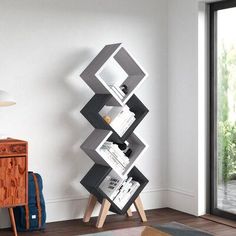 a modern bookcase in the corner of a living room