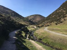 a narrow road in the middle of some mountains