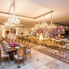 a fancy dining room with chandeliers and flowers