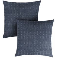 two dark blue pillows sitting on top of each other