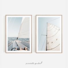 two framed photographs of sailboats in the ocean