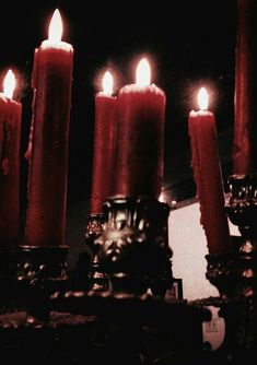 several lit candles sitting on top of a table