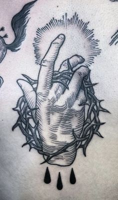 a black and white tattoo with a hand in the middle of it, surrounded by water drops