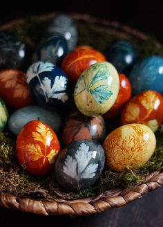 an arrangement of painted eggs in a basket