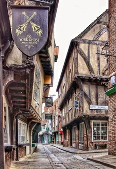 an old street with buildings and signs on it