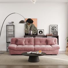 a living room filled with furniture and a pink couch