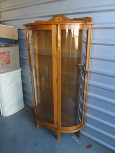 Vtg oak curio w/bowed glass front decorative accents vtg oak curio cabiner, beautiful light oak stained cabinet with bowed front of glass, top has decorative back with floral carving in center decorative accents on front 3 glass shelves, with light works 4 legs 61'' tallest  35'' widest  18'' deepest 56.5'' to top tall 33.5'' wide back 7.5'' tall legs on back says c-52-d-jj good used vtg condition normal wear for age and use offers welcome furniture 11-19-24 life c122 please note this is a used & or vintage item. they are not always perfect. however, i try to note any issues and overall condition. they are as found condition. any questions ask prior to purchase Kitchen Cabinet Inserts, Antique Curio Cabinet, Cabinet Inserts, Staining Cabinets, China Cabinets, Light Works, Display Cabinets, Oak Stain, Curio Cabinet