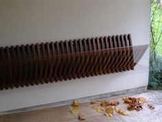 a radiator with leaves on the ground next to it