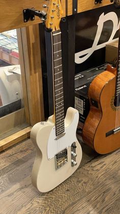 two guitars are sitting next to each other