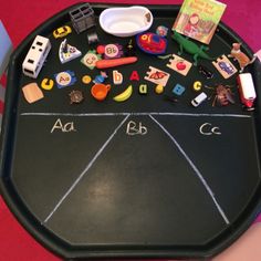 a black chalkboard with toys and letters on it