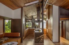 an open kitchen and living room area with wood flooring on both sides of the room