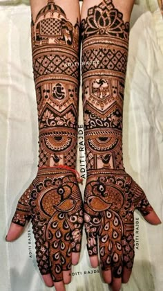 two hands with henna designs on them, one is showing the intricate pattern and the other has an elaborate design