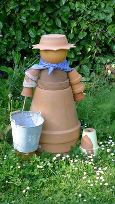 a garden sculpture made out of clay in the grass