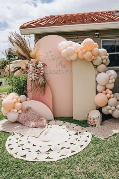 a pink and white wedding arch with balloons on it in front of a house that says together we are cocozonenex