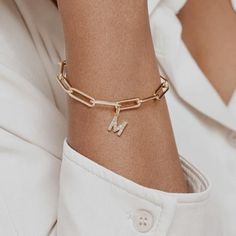 Elevate your style with our Paperclip Chain Diamond Initial Bracelet. Crafted in 14k gold filled, this bracelet features a trendy paperclip chain leading to your chosen initial, beautifully adorned with a sparkling cubic zirconia. Each piece of jewelry is handcrafted and designed in our studio. Material: 14k gold filled Stone: Cubic zirconia Chain Style: Paperclip Customizable: Choose your initial Perfect for any occasion--casual days, formal events, or special celebrations--this bracelet makes Gift Diamond Bracelet With Paperclip Chain, Gold-tone 14k Gold Paperclip Bracelet Gift, Classic Gold-tone Paperclip Bracelet With Adjustable Chain, Elegant Gold-tone Paperclip Link Bracelet, Alphabet Bracelet, Adjustable Letter-shaped Gold Bracelet, Chain Diamond, Bracelet Initial, Letter Bracelet