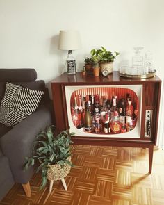 a living room with a couch, table and potted plant on top of it